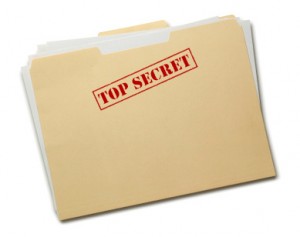 A manilla folder with the words top secret in red inside a red box