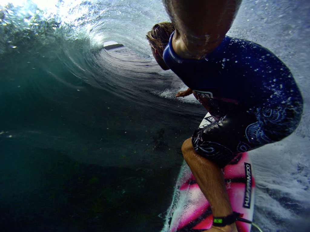 Surfer Byron Bartlett goes deep in the tube of a beatufifull wave, captured using a GoPro sports video camera.
